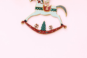 Stylish christmas horse toy flat lay on pink background with gol, a Holiday Photo by Sonjachni