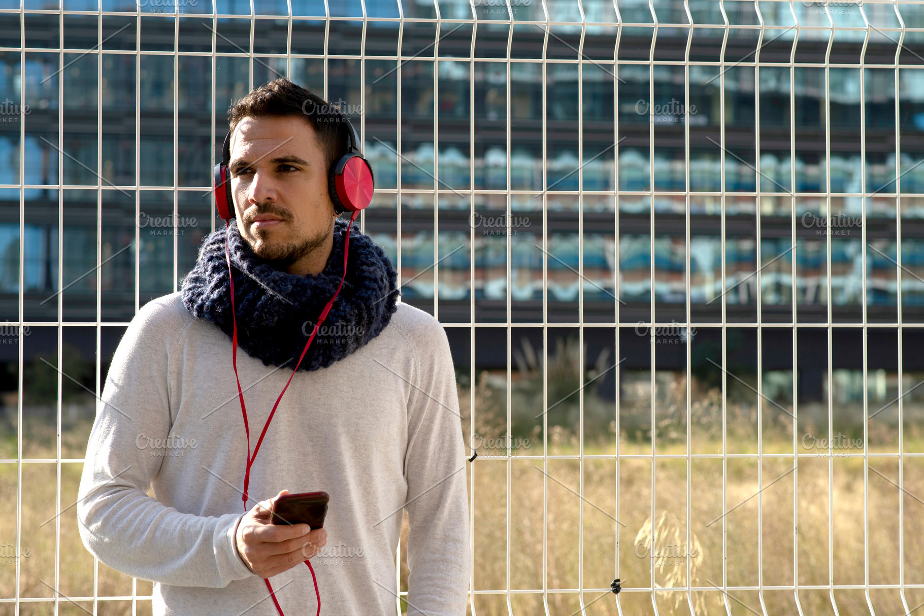 Caucasian man listening to music with smartphone outdoors, a Person Photo by RF Images