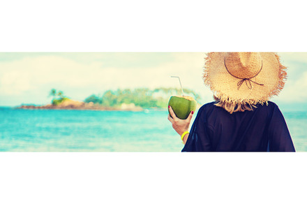 Girl on the beach drinks coconut, a Person Photo by yanadjana