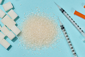 Different types of sugar and medical syringes on a blue backgrou, a Food & Drink Photo by ndanko