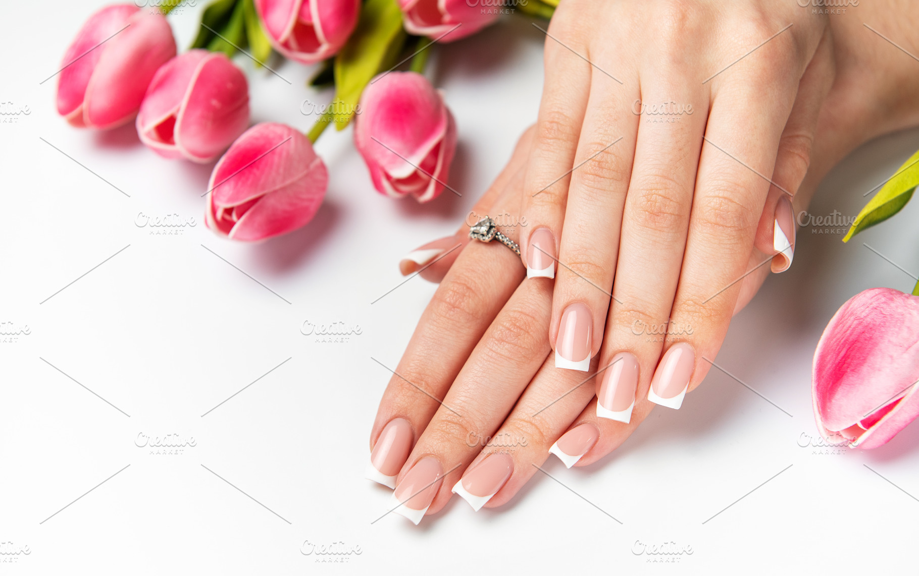 Woman showing french manicure and pink tulips on white backgroun, a Beauty & Fashion Photo by Olena Rudo