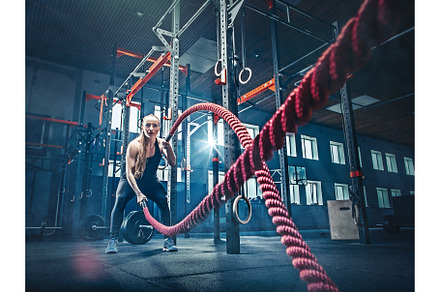 Woman with battle rope battle ropes exercise in the fitness gym featuring, a Sports & Recreation Photo by Volodymyr Melnyk