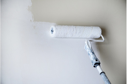 Hand painting wall with paint roller