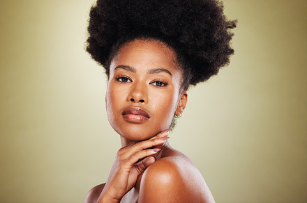 Black woman, portrait and beauty with skincare, hair care and cosmetic makeup in studio background. Model, afro and fashion with skin wellness or cosmetics for healthy facial texture and hygiene, a Photo by Peopleimages.com