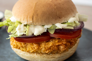 Crispy chicken burger on plate with lettuce tomato and sauce, a Food & Drink Photo by etorres69