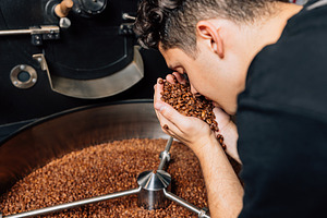 Barista smelling fresh beans, a Food & Drink Photo by Artem Varnitsin