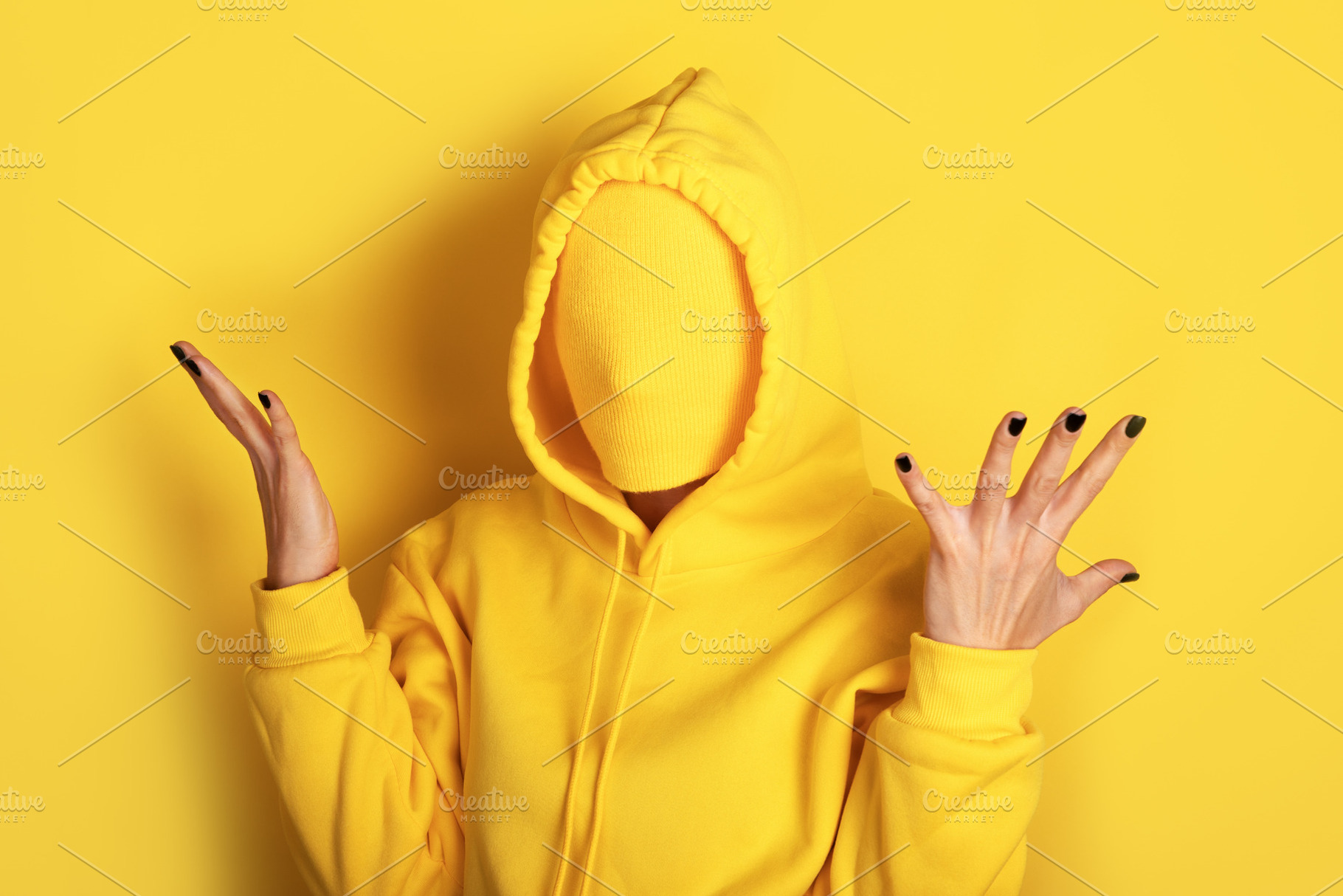 Unrecognizable figure in a yellow sweatshirt with covered face,, a Person Photo by Ales Munt