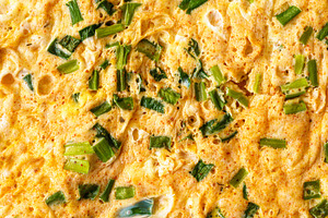 Macro shot capturing the texture of a homemade omelet cooked with fresh green o, a Food & Drink Photo by Eugene_Photo