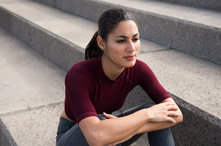 Attractive young woman sitting on st