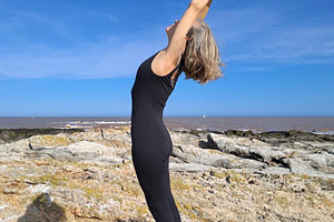 Woman practices pilates on a rugged rocky surface, a Sports & Recreation Photo by DanFLCreativo