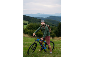 miling mature man with bicycle, a Sports & Recreation Photo by HalfPoint