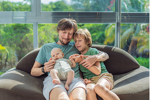 Father, son, and newborn baby, a Person Photo by Elizaveta Galitskaya