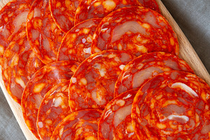 Cold Meat Chorizo Slices on a Wooden Board, top view., a Food & Drink Photo by LiudmylaChuhunova