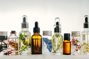 Transparent bottles of essential oil containing essential, oil, and oils