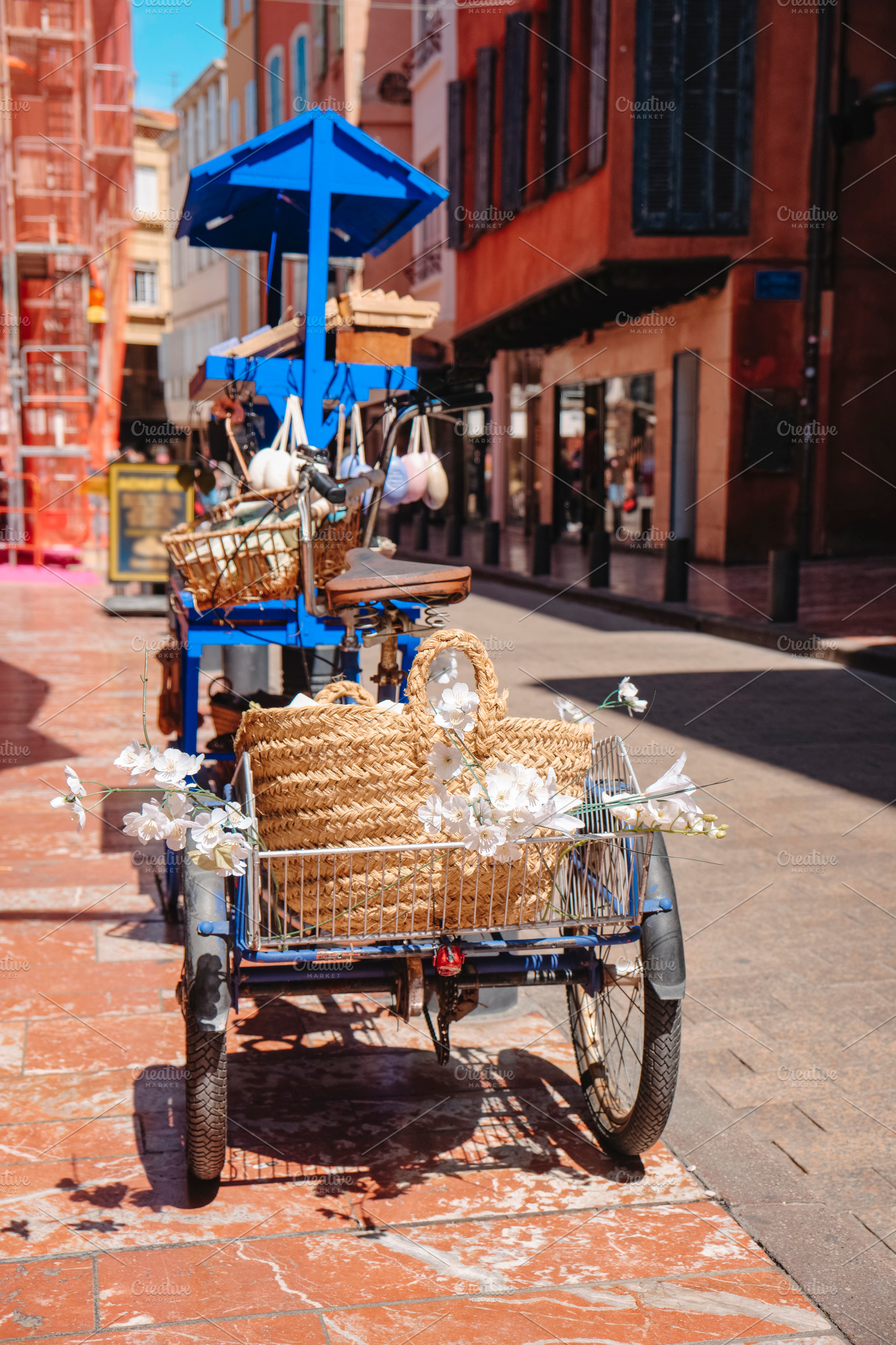 boho-chic blue tricycle in Perpignan, France, a Photo by Nito