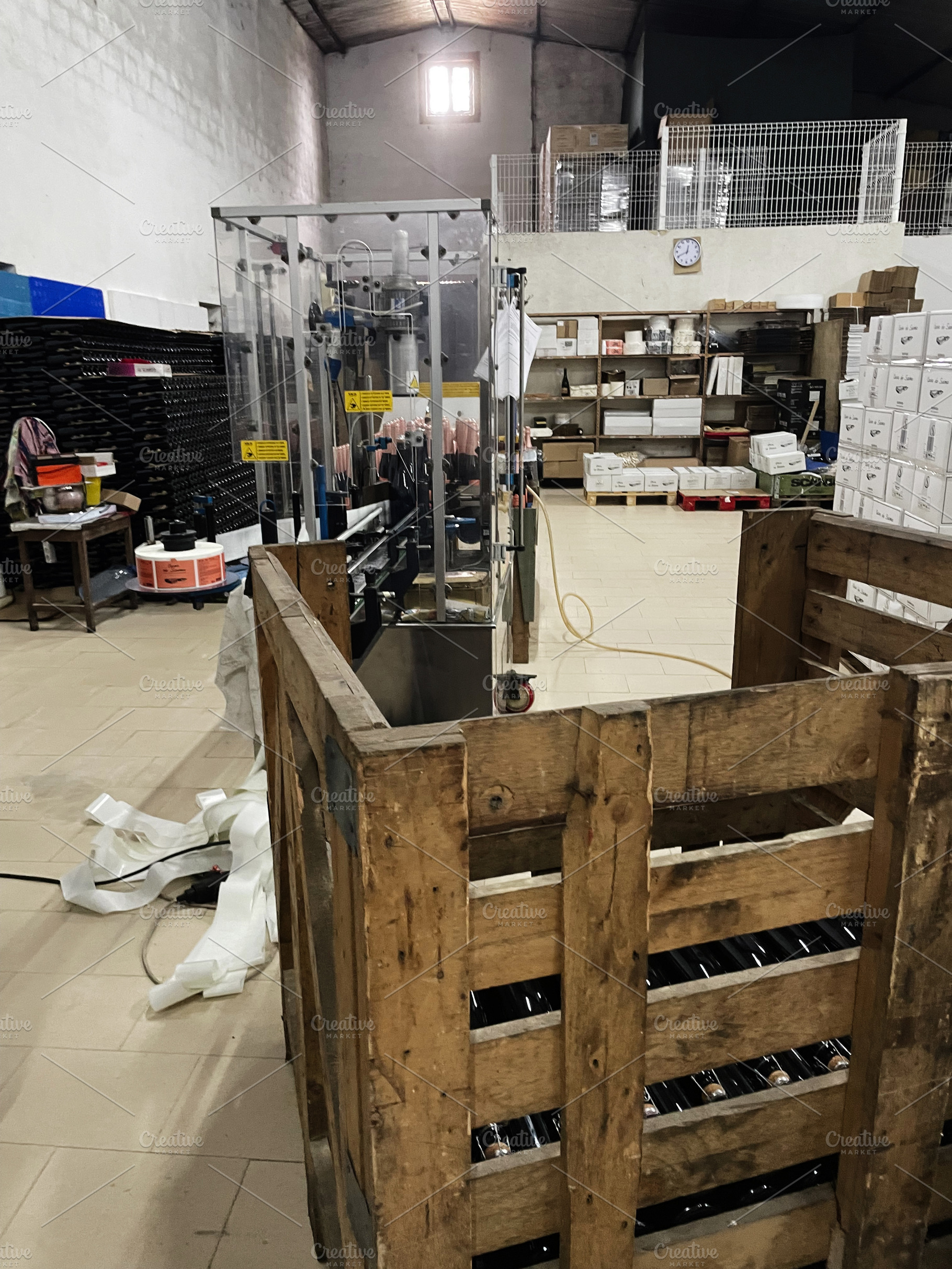 Industrial warehouse with stocked shelves and machinery for bottle packaging, a Photo by AS photostudio