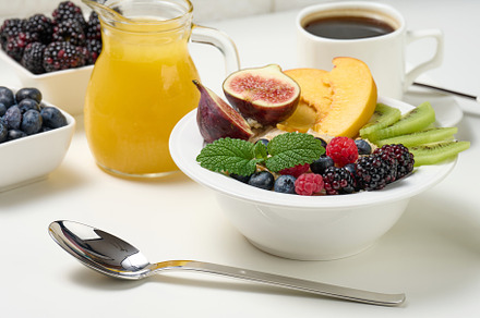 full plate with oatmeal and fruit, freshly squeezed juice in a t, a Food & Drink Photo by ndanko