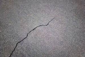 Black & white crack in street asphal