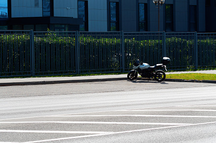 Right aligned motorcycle on empty parking backdrop, a Transportation Photo by RETROWAVE '88