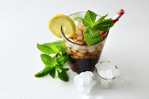 Refreshing cola drink with ice on white table elevated view, a Food & Drink Photo by Davizro's Market
