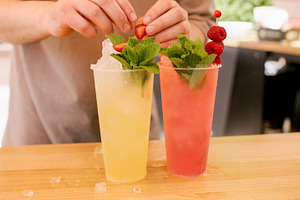 Garnishing cocktails refreshing beverages hand ice, a Food & Drink Photo by Photo Drive Studio