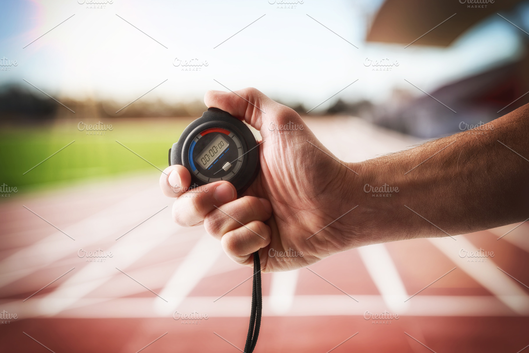 Person with a stopwatch in hand on an athletics track, a Sports & Recreation Photo by Davizro's Market