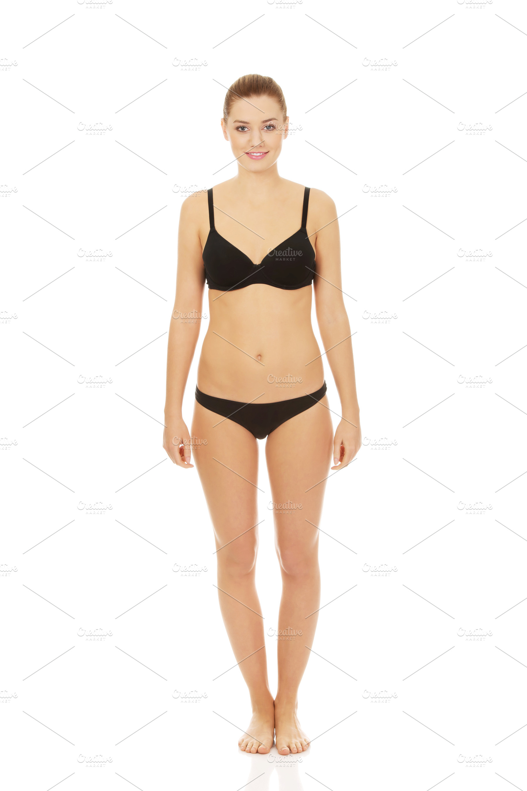 Happy woman standing in bikini., a Person Photo by PhotoMediaGroup