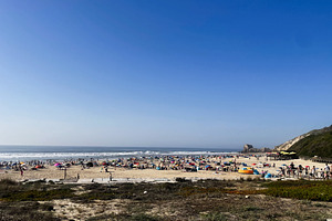 Crowded beach on a sunny day at Praia das Azenhas, Portugal coastline, a Photo by AS photostudio