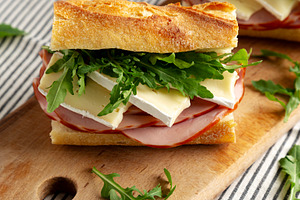 Homemade French Ham and Brie Baguette with Arugula Greens, side, a Food & Drink Photo by LiudmylaChuhunova