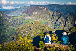 Older friends sitting in mountains, a Sports & Recreation Photo by Alpine Dreams