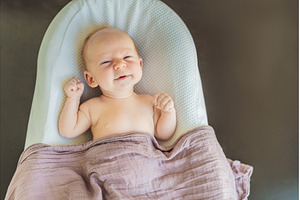 Newborn baby comfortably resting in, a Health & Medical Photo by Elizaveta Galitskaya