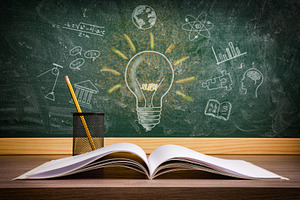 Study in education with book and blackboard with drawings, a Photo by Davizro's Market