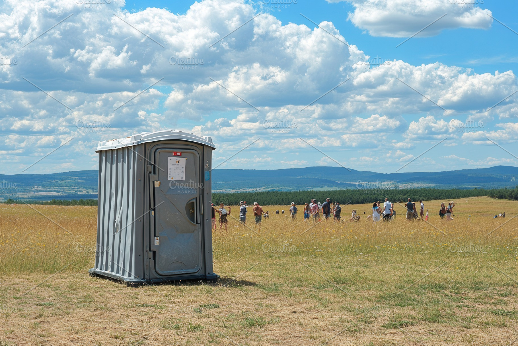A portable toilet in a field, a Photo by Pavel_design