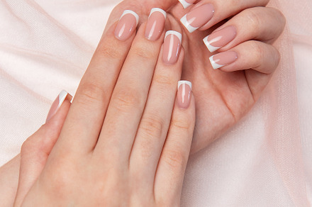 Woman showing french manicure on pink background