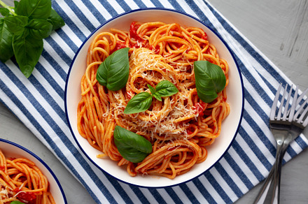 Homemade Pasta Pomodoro on a Plate, top view. Flat lay, overhead, a Food & Drink Photo by LiudmylaChuhunova