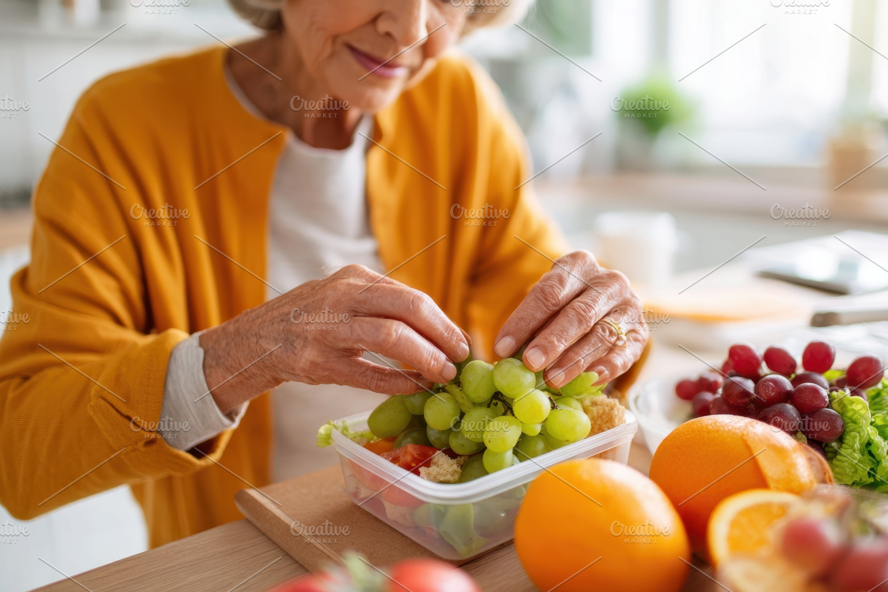 Elderly woman preparing a healthy fruit meal, a Food & Drink Photo by AlyaAnd