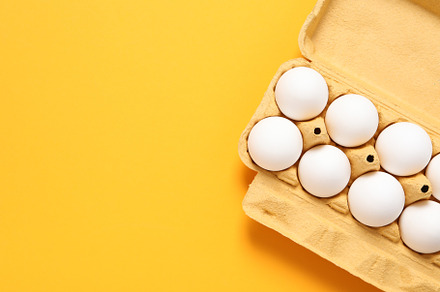 Egg box with eggs, space for text, a Food & Drink Photo by AtlasStudio PRO