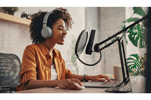 A cheerful woman in headphones, a Technology Photo by Igor Tichonow