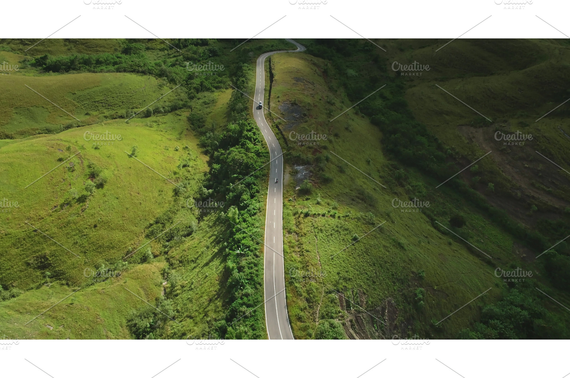 Cars driving on winding road in, a Nature Photo by Goinyk