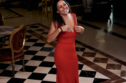 young brunette woman smiling with a red dress in the living room, a Beauty & Fashion Photo by YossSabalet