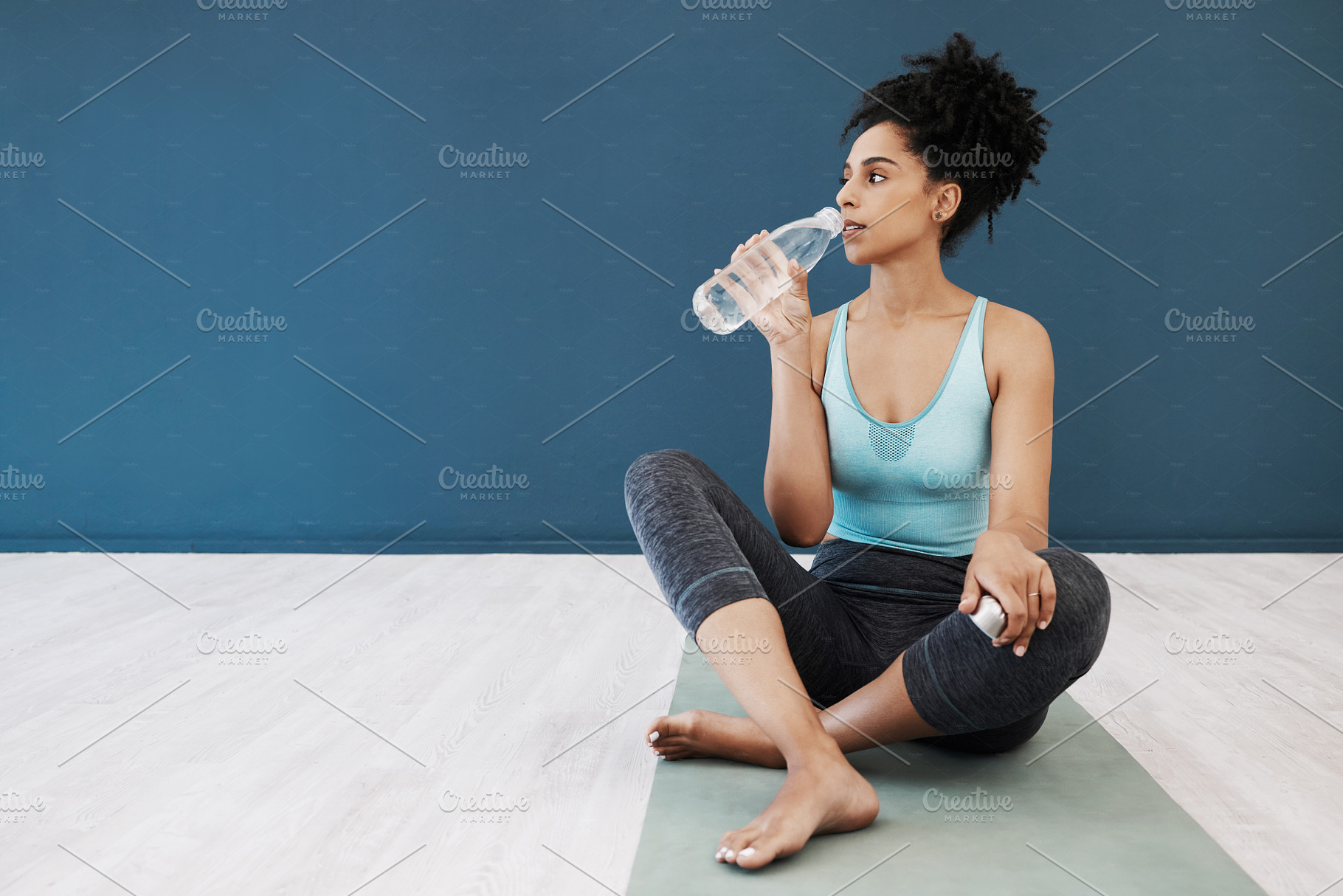 Tired, fitness or woman drinking water in gym for fitness training, workout exercise or health. Athlete, wellness or relax girl with water bottle for sport hydration, mockup or rest energy in studio, a Photo by Peopleimages.com