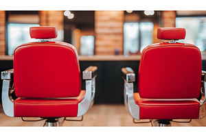 Empty red barber chairs in modern, a Business Photo by Lermont51