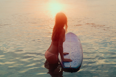 Rear view of beautiful surfer girl, a Sports & Recreation Photo by SkyNext