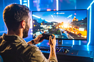 Gamer intensely focused on a video game, gripping a controller w, a Technology Photo by DanFLCreativo
