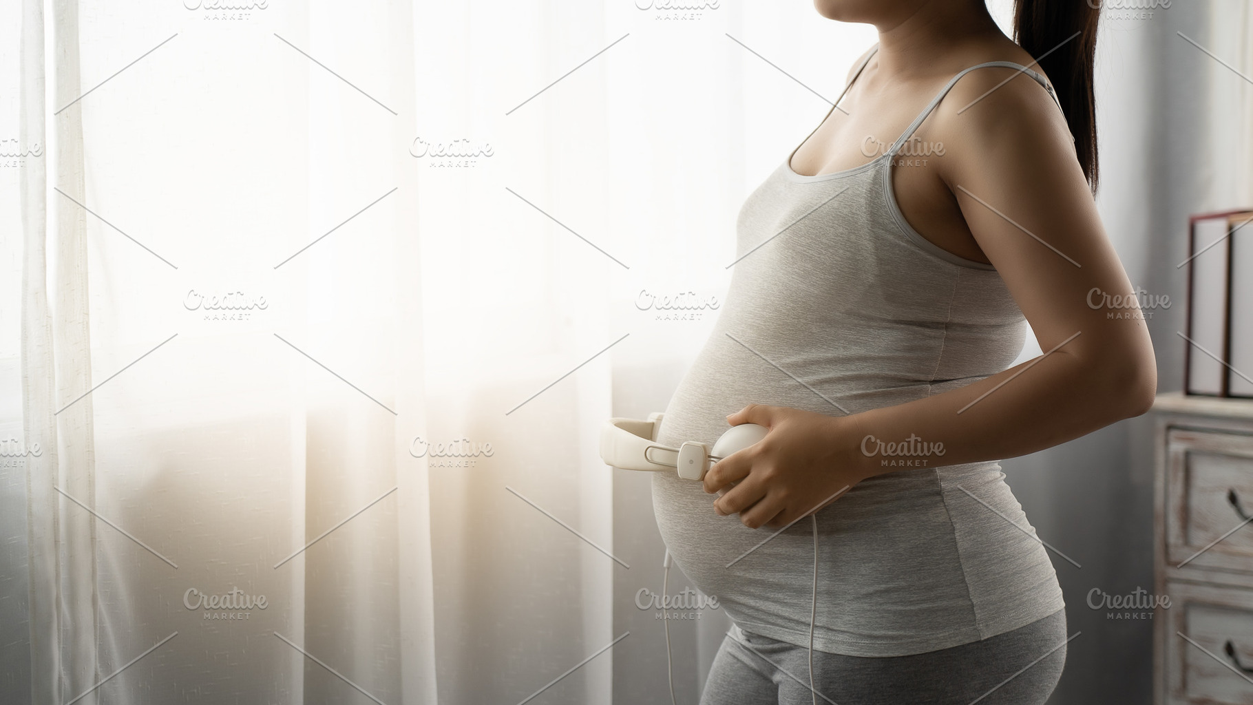 Pregnant  are listening to music, a Person Photo by Guitarfoto Studio