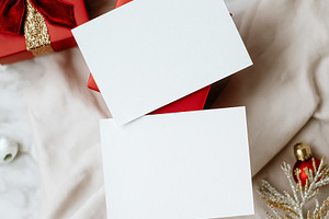 Holiday greeting card mockup with blank white paper on a red gift box and Chris, a Holiday Photo by Studio ANNA