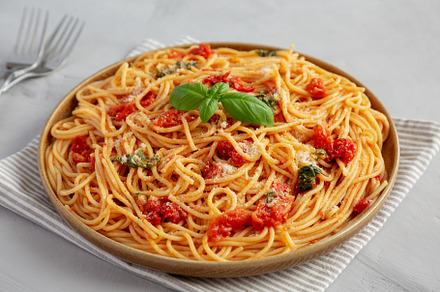 Homemade Spaghetti With Fresh Tomato Sauce on a Plate, side view, a Food & Drink Photo by LiudmylaChuhunova