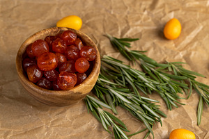 boiled with sugar syrup candied fruits of small fruits of kumquat, a Photo by rsoollAI