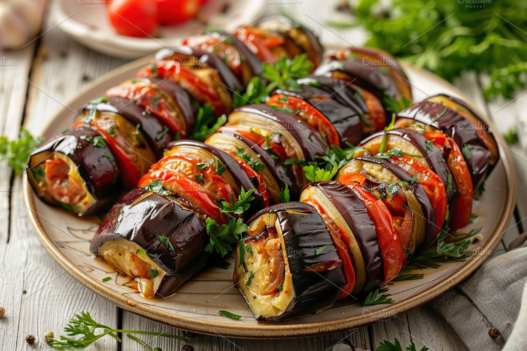 Rolled up eggplant stuffed with cheese and tomatoes in plate, a Food & Drink Photo by AlyaAnd