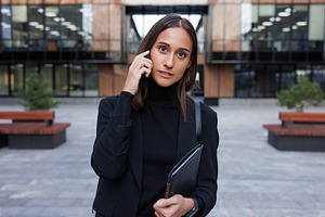 Young woman talking on mobile phone, a Business Photo by Artem Varnitsin